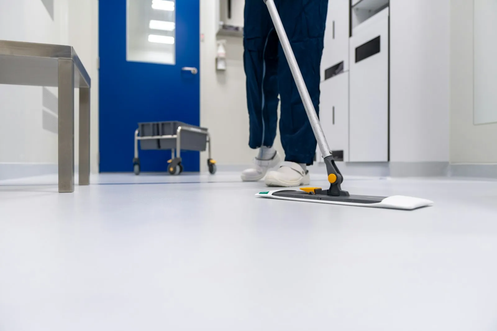 Cleaner mopping a bright commercial floor